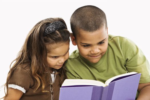Boy and girl reading book together.
