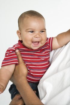 Man holding little hispanic baby.