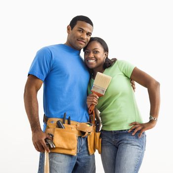 Portrait of African American male and female couple with home repair tools.