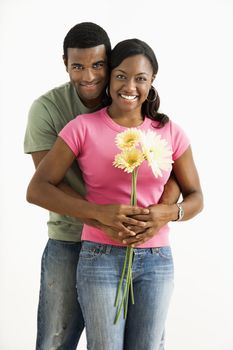 Portrait of smiling African American couple standing looking at viewer.