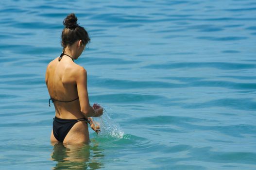 Young girl bathing in the sea afternoon