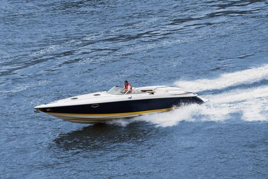 Speedboat cruising in the river. Fast drive