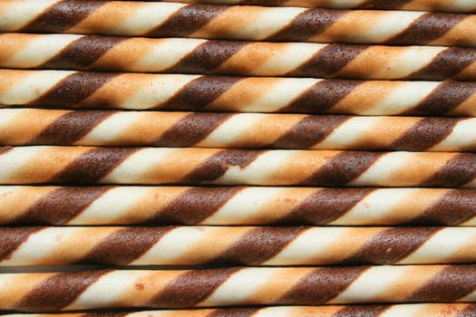 Close up of chocolate cookie sticks on a plate.
