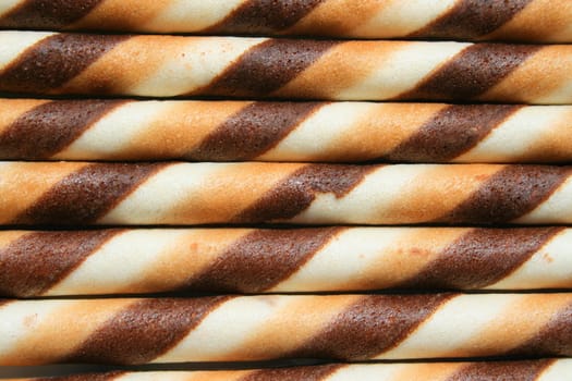 Close up of chocolate cookie sticks on a plate.
