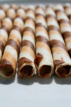 Close up of chocolate cookie sticks on a plate.
