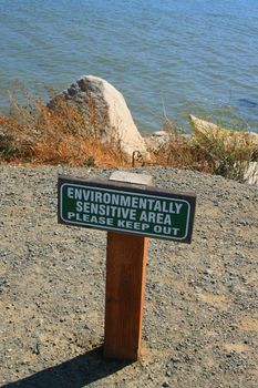 Close up of an environmentally sensitive area sign.
