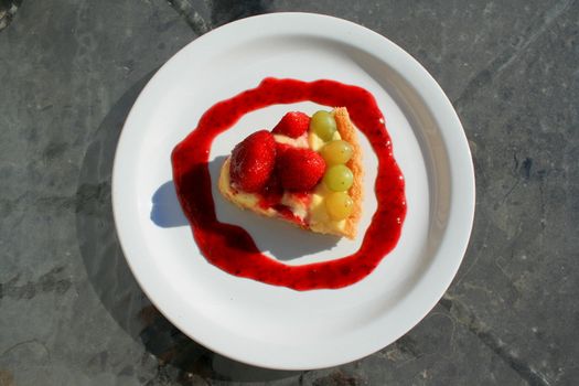 Close up of a fruit cake slice on a plate.
