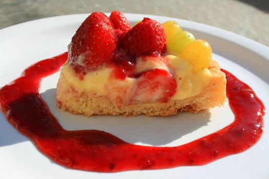 Close up of a fruit cake slice on a plate.
