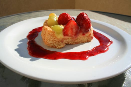 Close up of a fruit cake slice on a plate.
