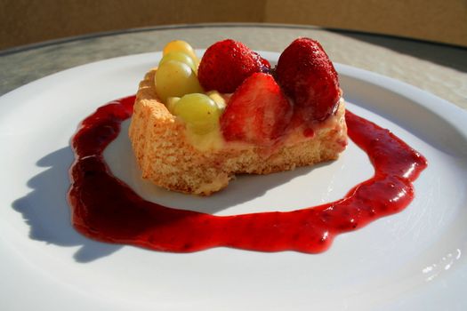 Close up of a fruit cake slice on a plate.
