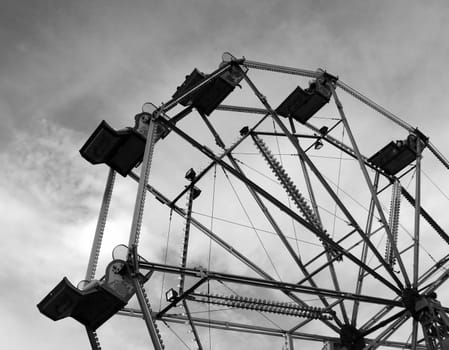 A ferris wheel in a fair ground.