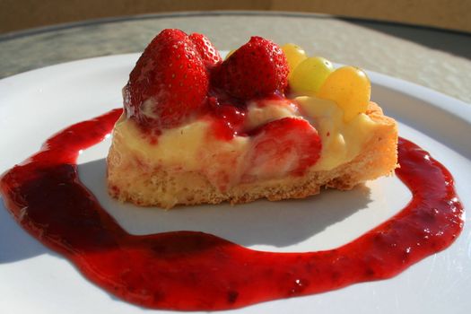 Close up of a fruit cake slice on a plate.
