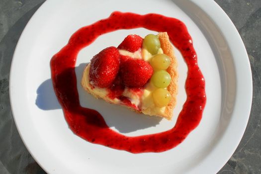 Close up of a fruit cake slice on a plate.
