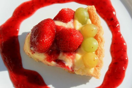 Close up of a fruit cake slice on a plate.
