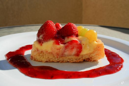 Close up of a fruit cake slice on a plate.
