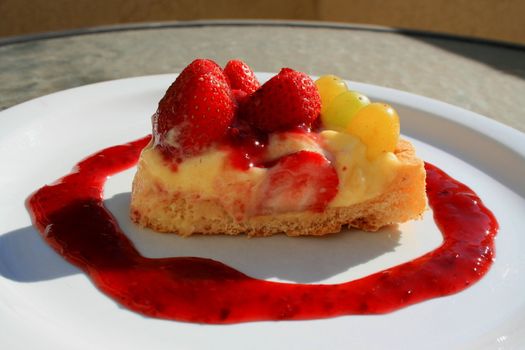 Close up of a fruit cake slice on a plate.
