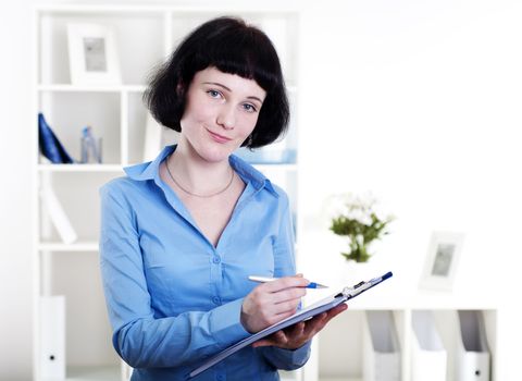 Portrait of a business woman in the office doing some paperwork