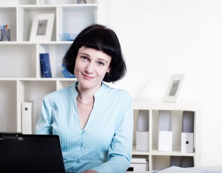 Portrait of a business woman in the office doing some paperwork