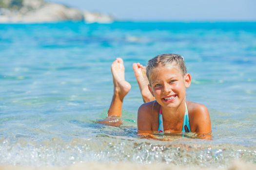 Portrait of young girl swimming in the transparent sea