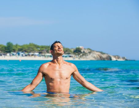 Young man having fun in oceans water