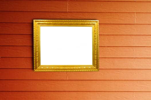 Golden frame on wood wall