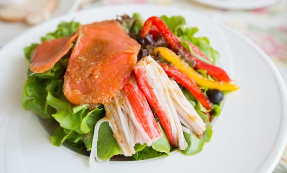 Salmon salad with avocado and sweet pepper, japanese gourmet appetizer