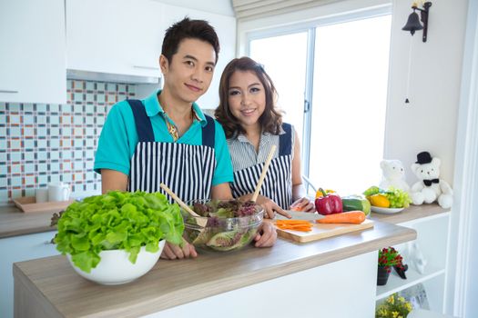 Young happy couples in domestic kitchen