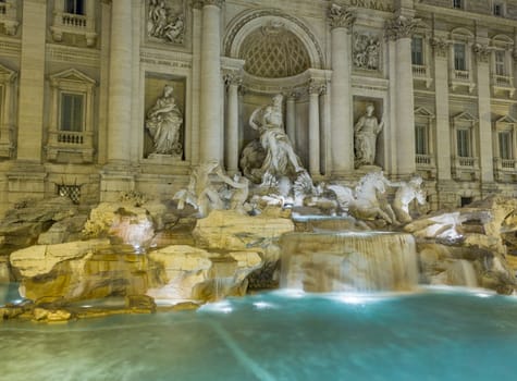 Night time floodlit details of statues in Trevi fountain in Rome Italy