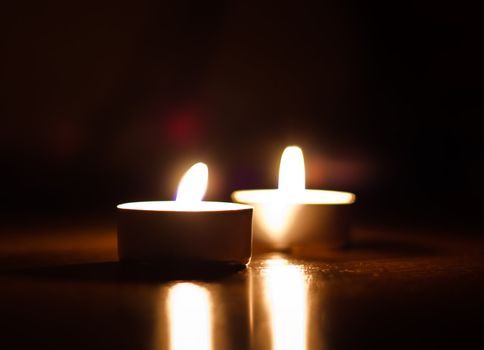 Closeup of two burning candles