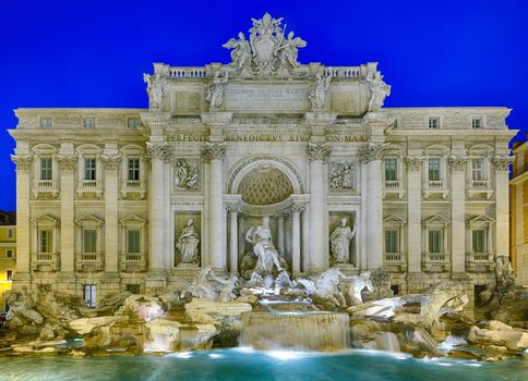 Night time floodlit details of statues in Trevi fountain in Rome Italy