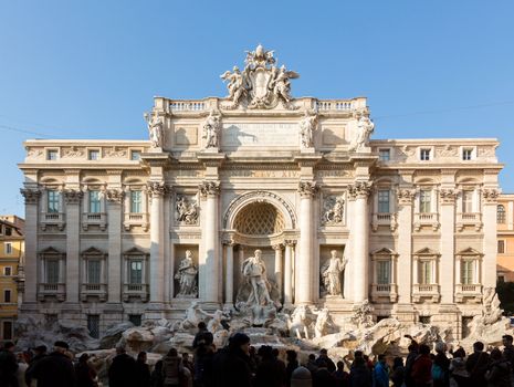 ROME, ITALY - JANUARY 27: Tourists throng the Trevi Fountain on January 27, 2013. It is 49m wide and is largest baroque fountain in Rome