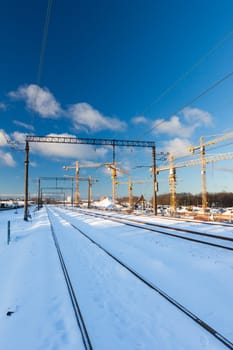 Huge industrial cranes on the construction site near rail road - winter season