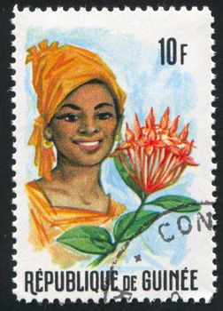 GUINEA CIRCA 1966: stamp printed by Guinea, shows Women and Flowers of Guinea, circa 1966