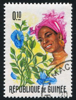 GUINEA CIRCA 1966: stamp printed by Guinea, shows Women and Flowers of Guinea, circa 1966