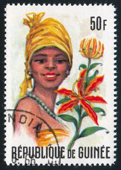 GUINEA CIRCA 1966: stamp printed by Guinea, shows Women and Flowers of Guinea, circa 1966