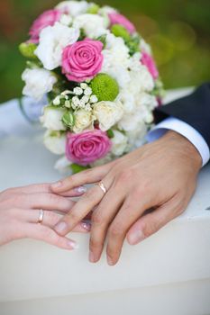 bouquet and wedding rings of bride and groom