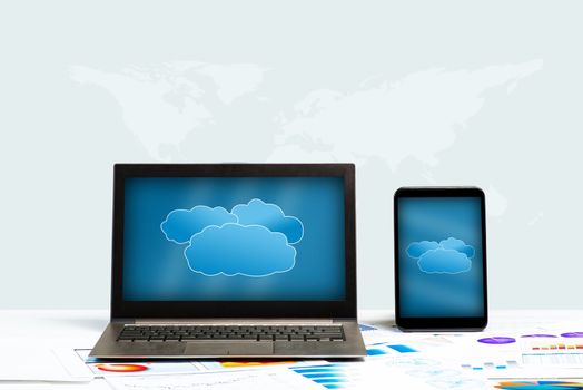 notebook, tablet and business documents with charts, concept of cloud technologies