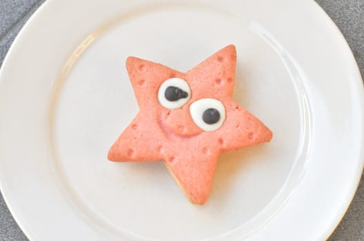Home made star shaped strawberry and vanilla chocolate cookie in a dish