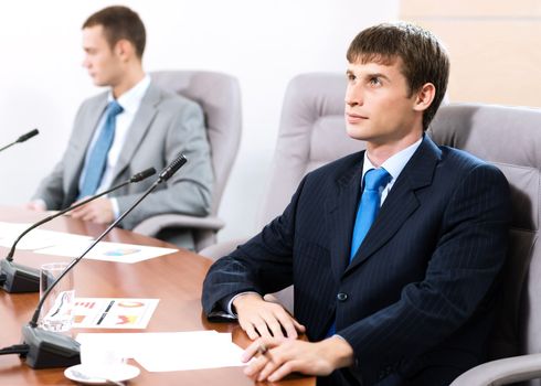 Portrait of a businessman, in the background colleagues communicate with each other
