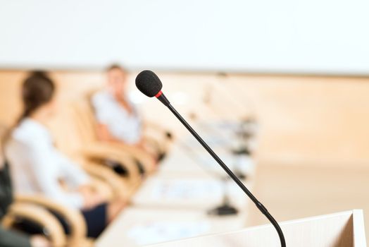 close-up microphone, on the background of business communication at the conference