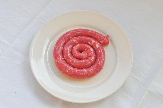 Detail of beef sausage in a dish