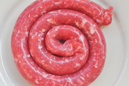 Detail of beef sausage in a dish