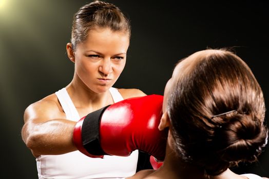 Aggressive boxing woman, hits an opponent in the head