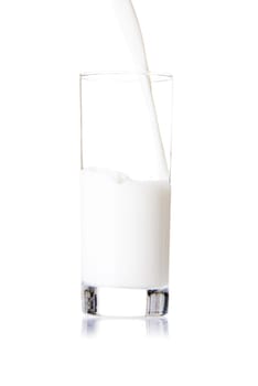 Pouring a glass of milk, isolated on white