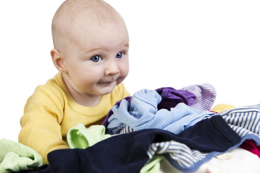 young child looking over many clothes