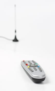 plastic remote control and antenna in backround. Depth of field. Colored keys on remote control