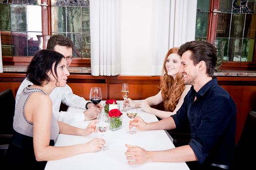 smiling happy people in restaurant drinking talking having fun 