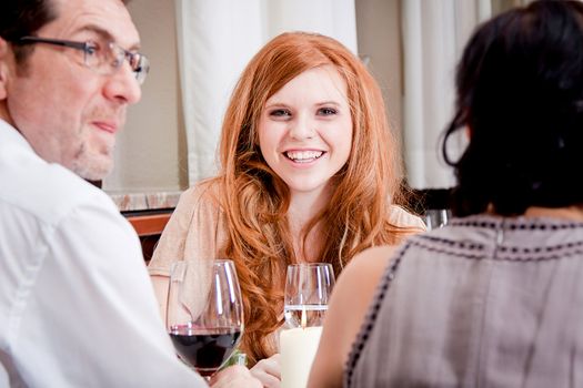 smiling happy people in restaurant drinking talking having fun 