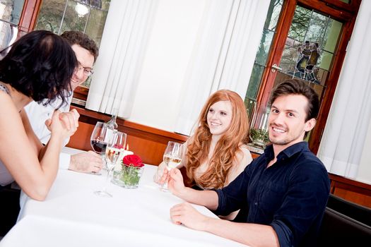 smiling happy people in restaurant drinking talking having fun 