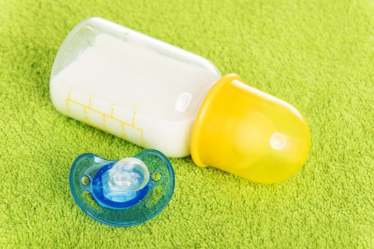 Baby milk bottle and dummy close up